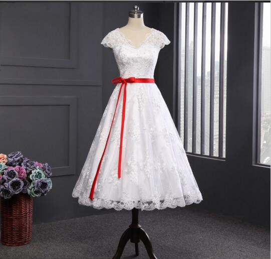 White wedding dress with red outlet sash